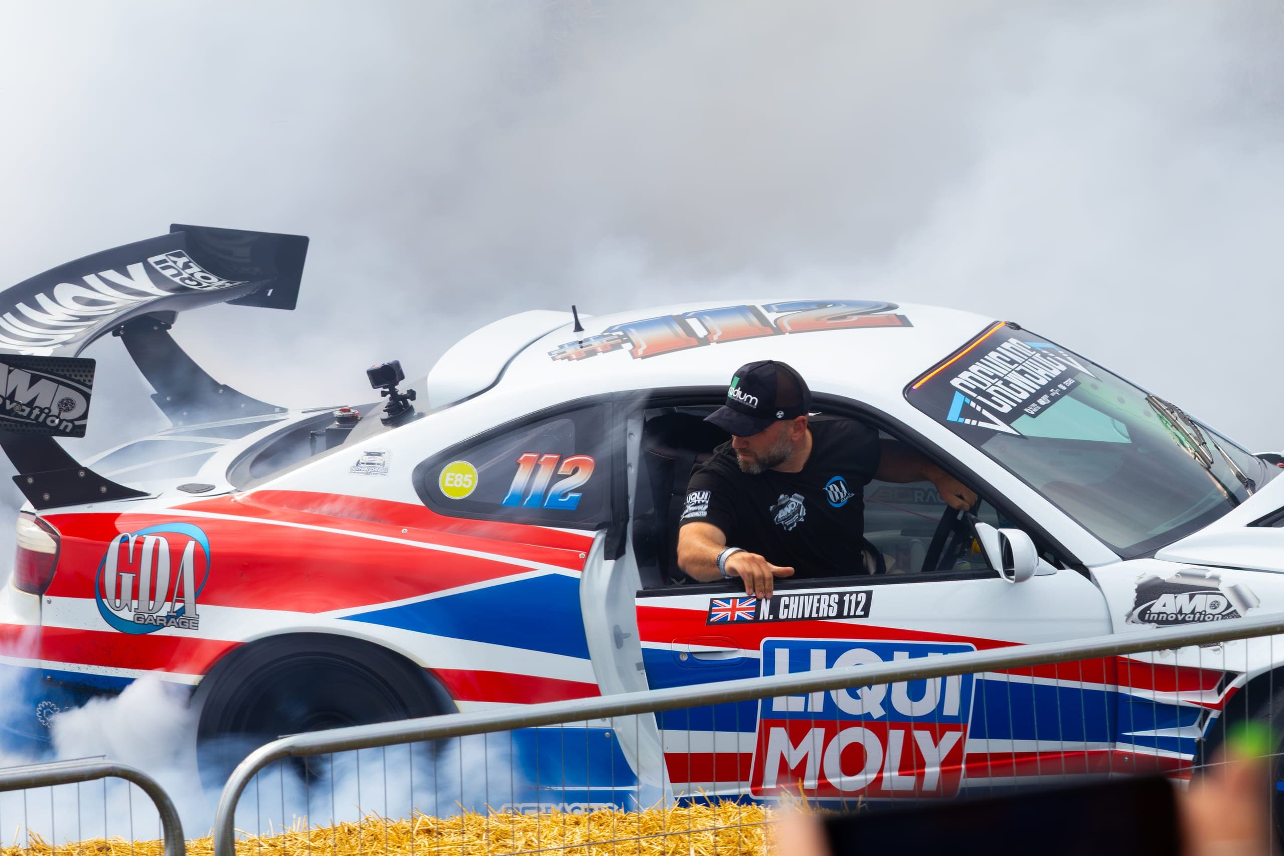 A race car and its driver waiting in the assembly area before a run, Gravity 2026