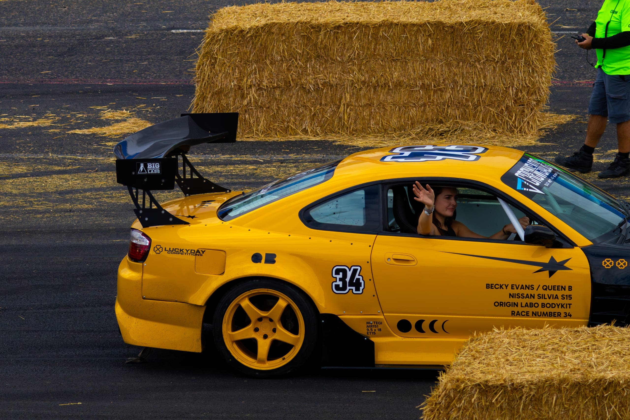 A drift car running tight along the hay bale barrier, Gravity 2026