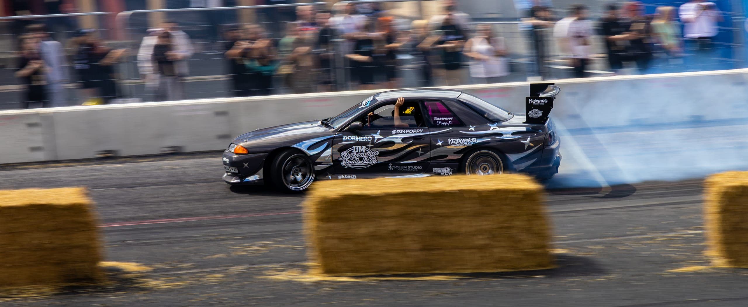 A drift car held on opposite lock through the corner, Gravity 2026