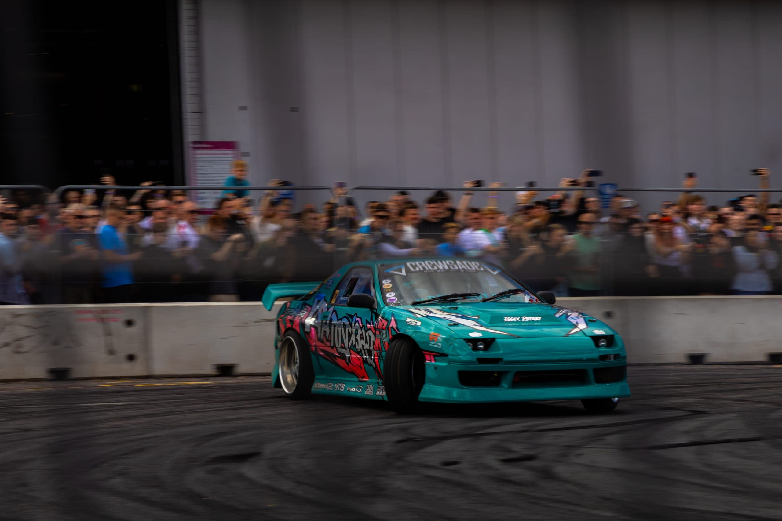 A drift car running the far wall in front of the crowd, Gravity 2026