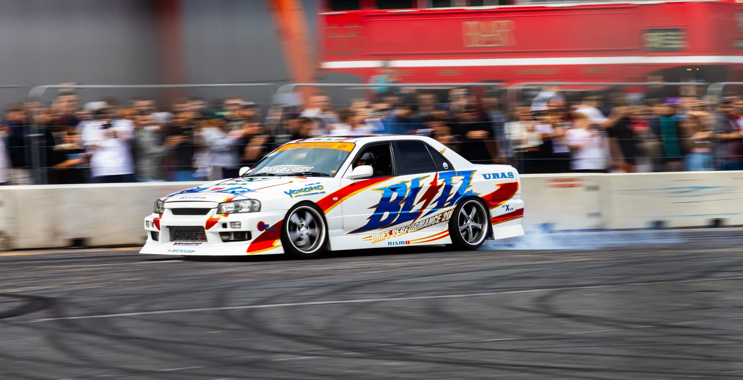 A blue and white liveried drift car mid-run, Gravity 2026