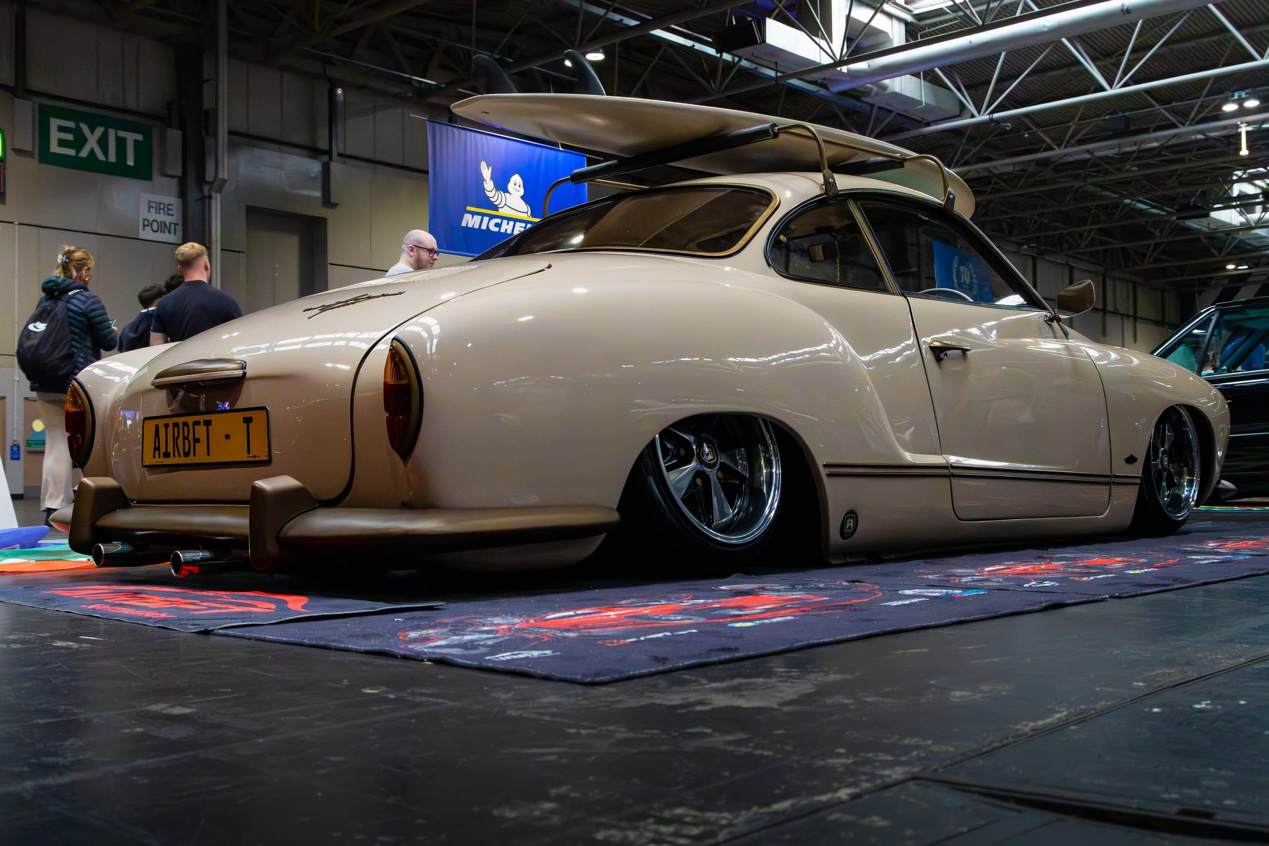 A slammed air-ride classic coupe on the show floor, Gravity 2026