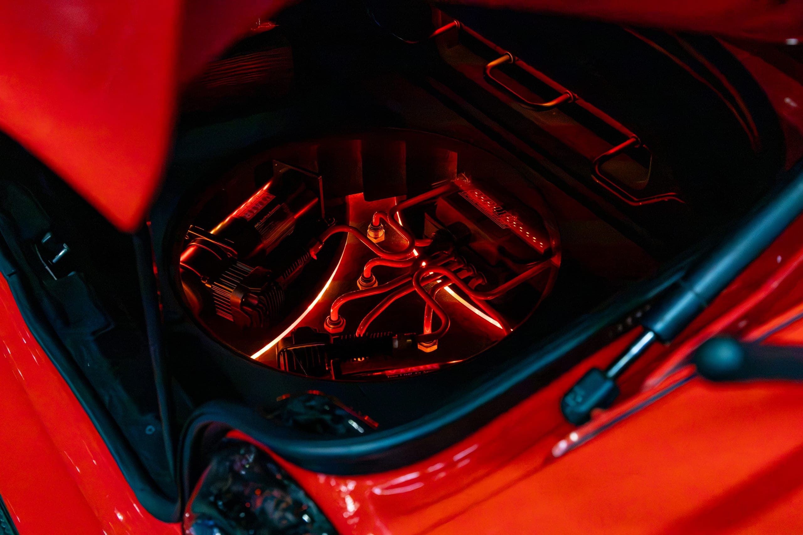 Suspension and wheel picked out in red light, Gravity 2026