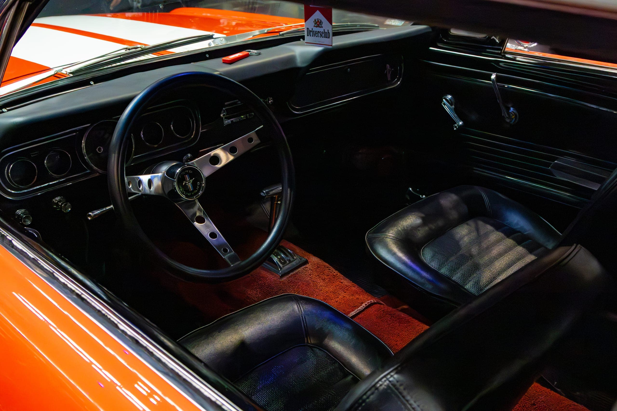 A wood-rimmed steering wheel and chrome dash, Gravity 2026