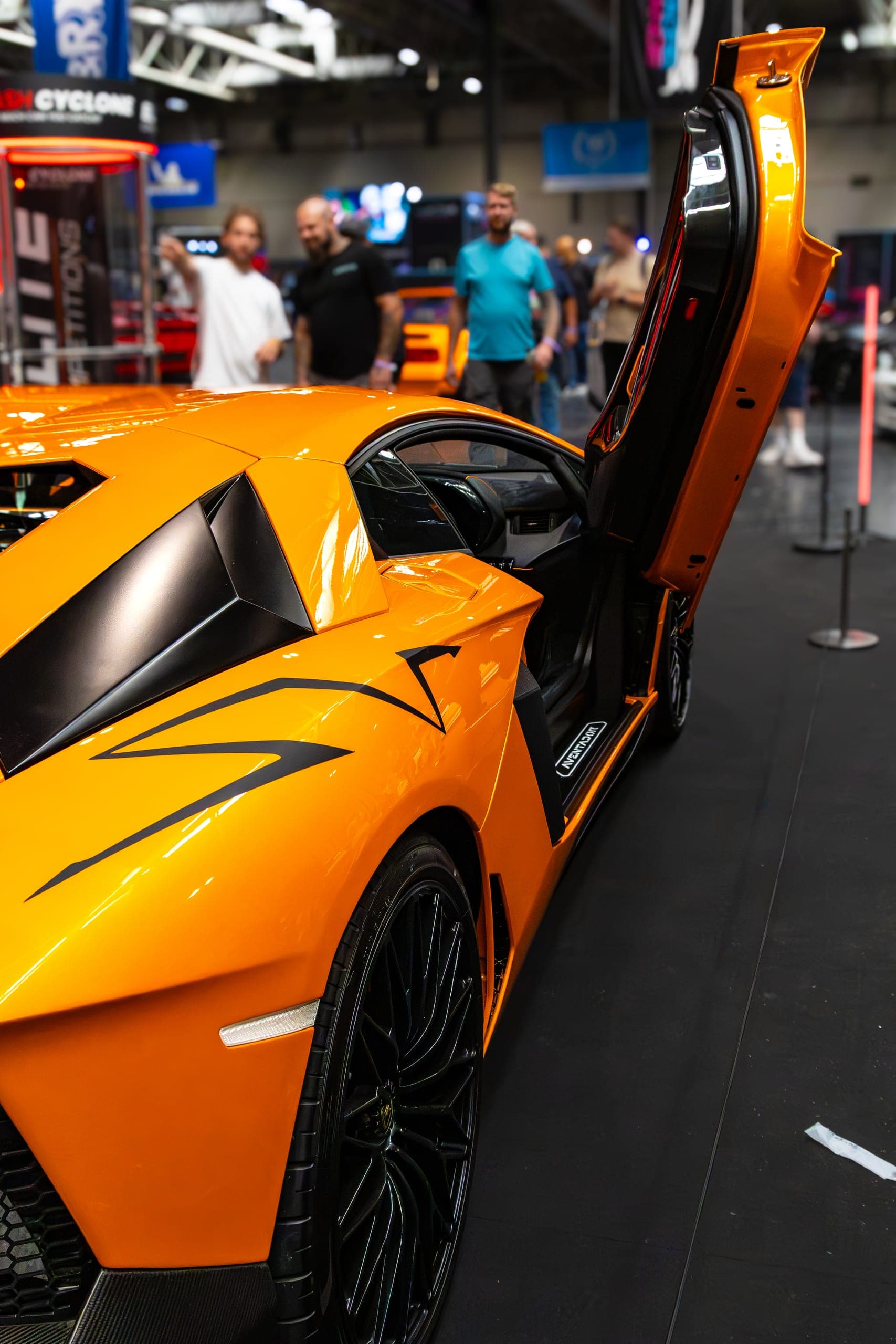 An orange supercar with its door raised, Gravity 2026