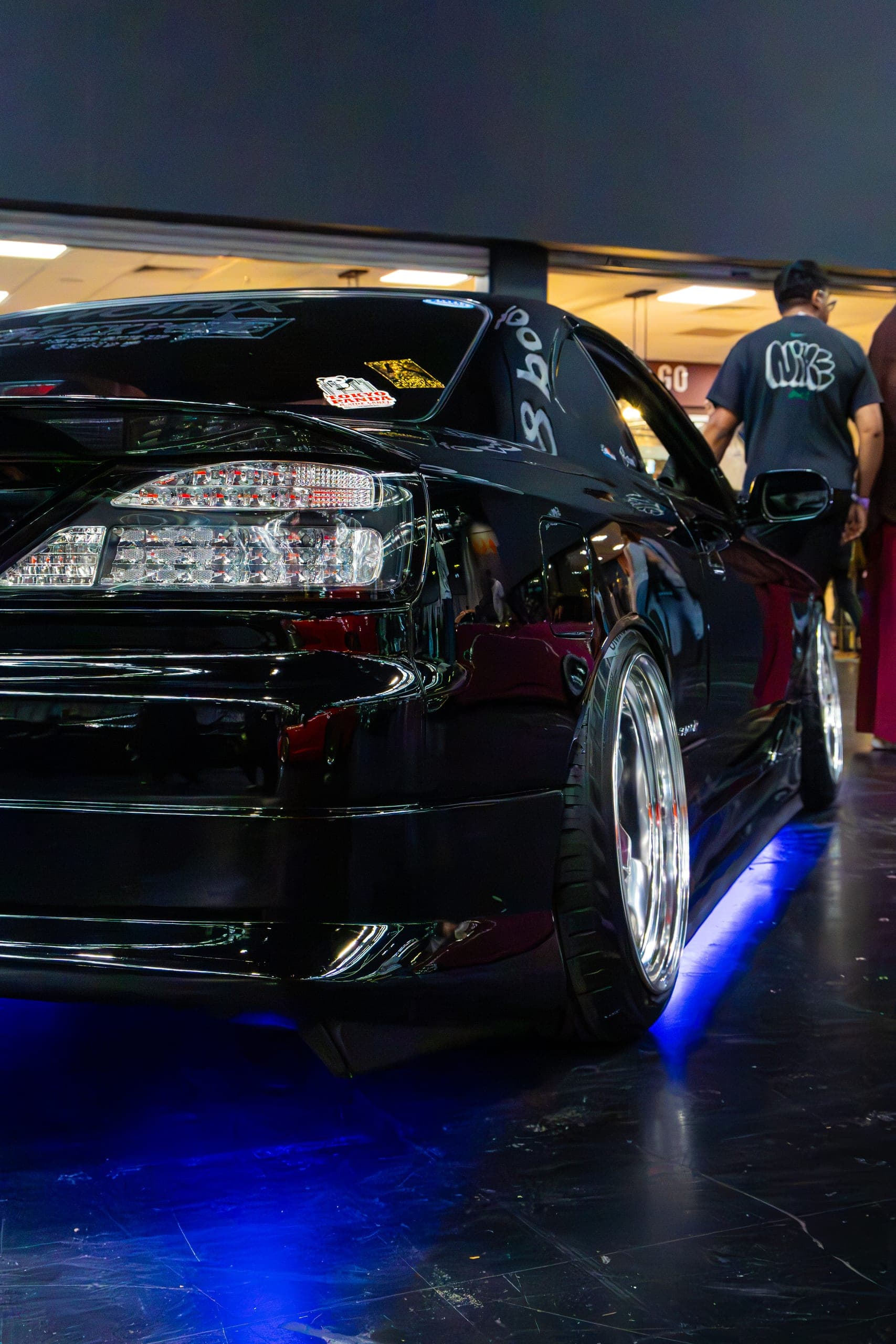 The rear of a low show car lit from below, Gravity 2026