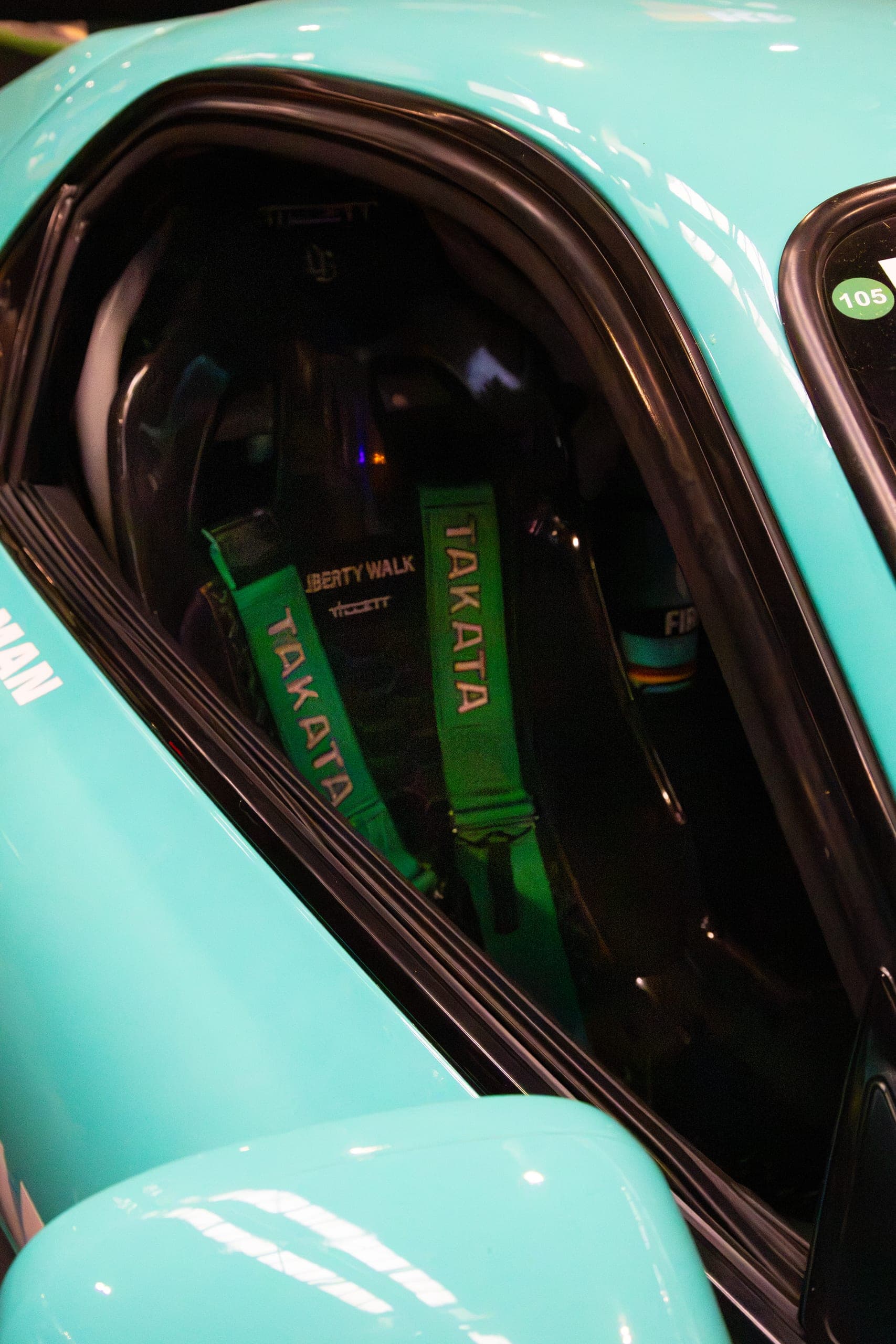 A racing harness against a teal interior, Gravity 2026