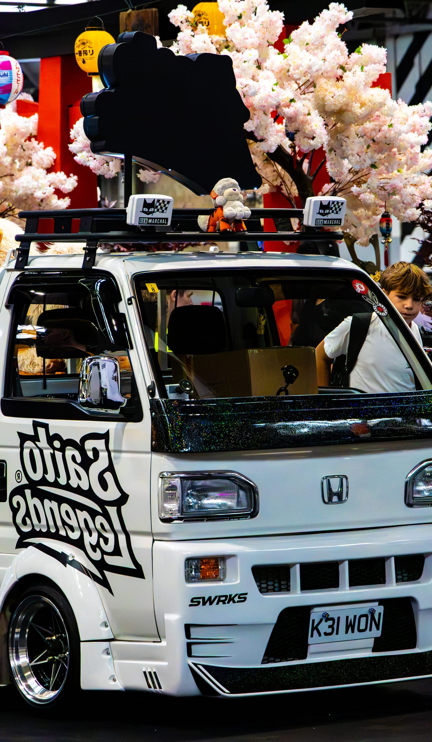 A decorated kei truck loaded with figures, Gravity 2026